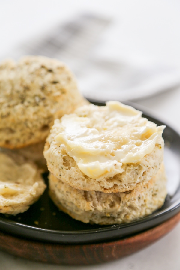 a buttered biscuit on a plate.