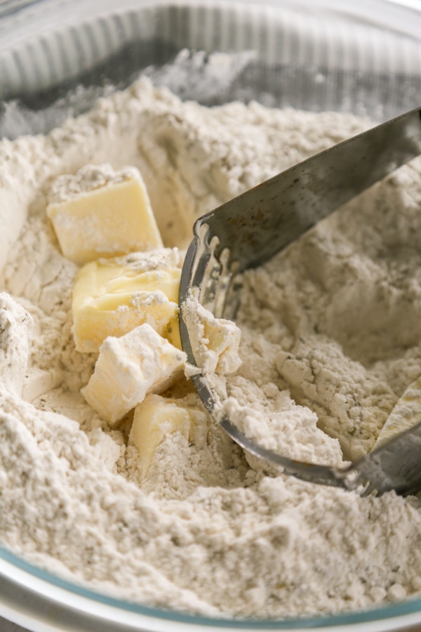 butter being cut into the dry ingredients.