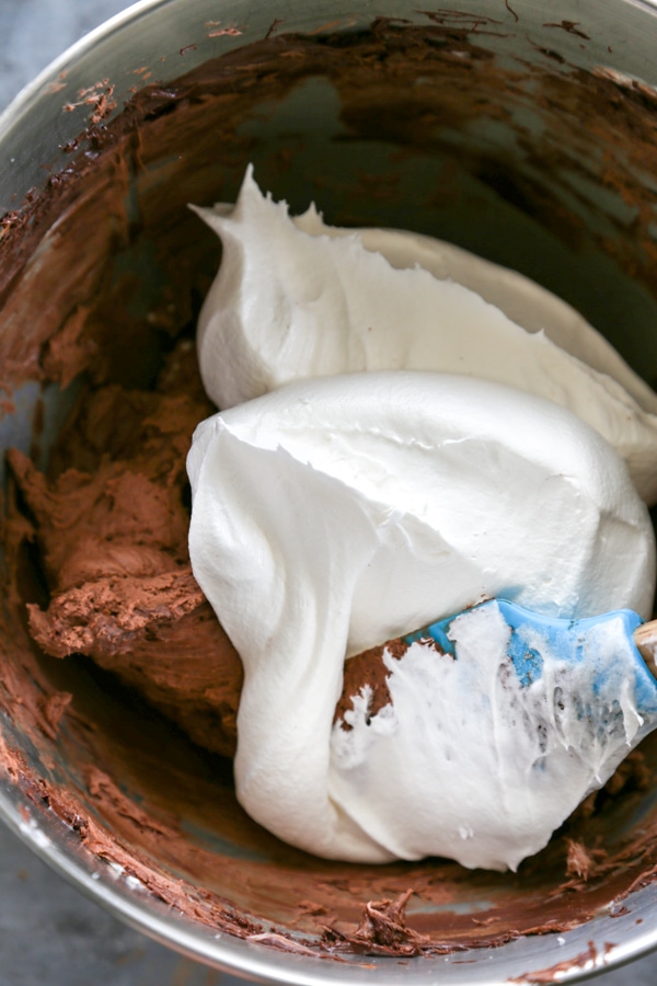 Cool Whip being added to the bowl.