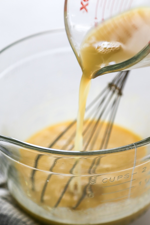 juice being poured into a bowl.