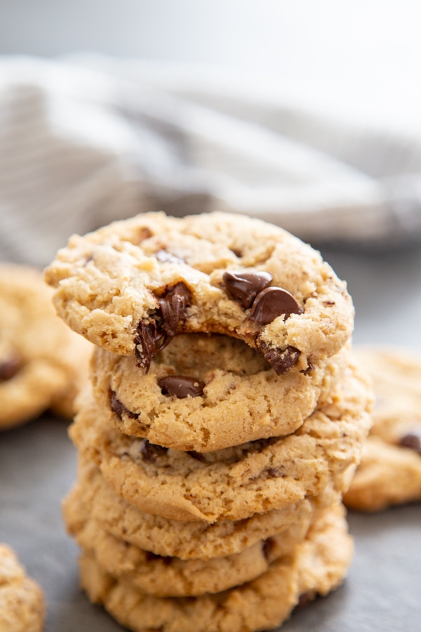 stack of vegan chocolate chips cookies with bite taken out of them