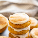 stack of pumpkin cookies frosted