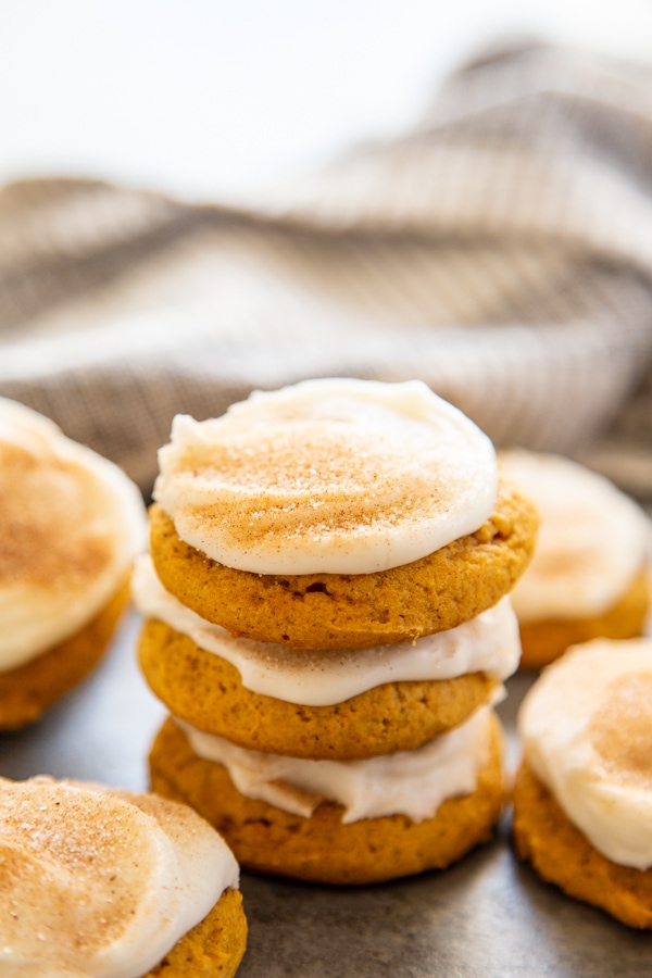 stack of frosted pumpkin cookies