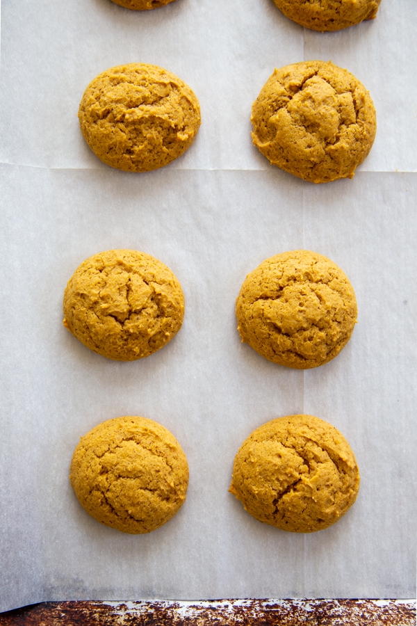 overhead shot pumpkin cookies on baking sheet