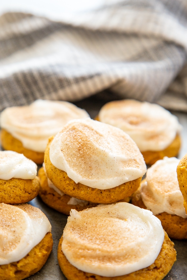 a dozen of frosted pumpkin cookies