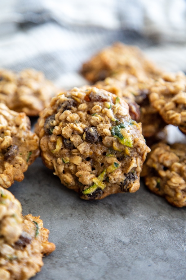 close up picture of zucchini cookies gathered on a board