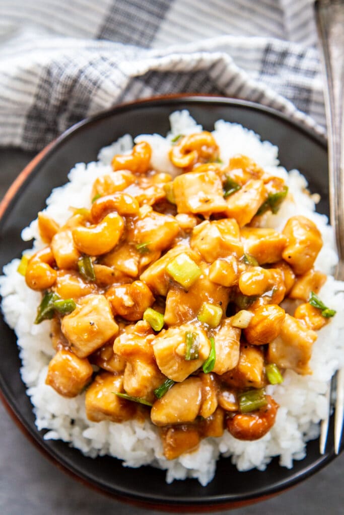 overhead shot of cashew chicken over rice on plate