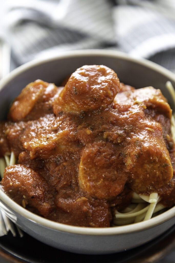 italian sausage spaghettis sauce in bowl with noodles