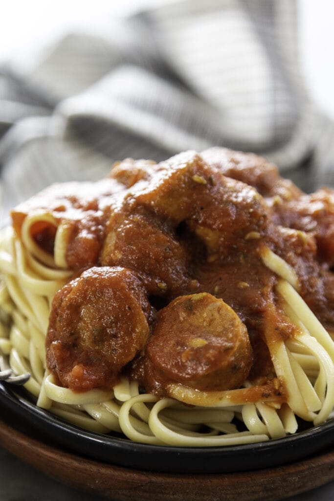 Italian Sausage Spaghetti Sauce over noodles on plate