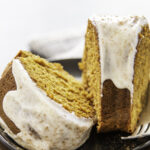 two pieces of cake with fork on black plate