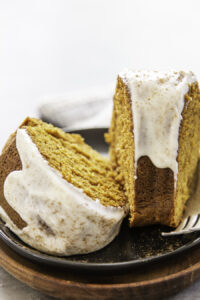 two pieces of cake with fork on black plate