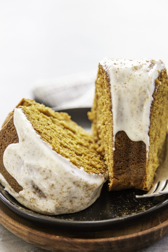 two pieces of cake with fork on black plate