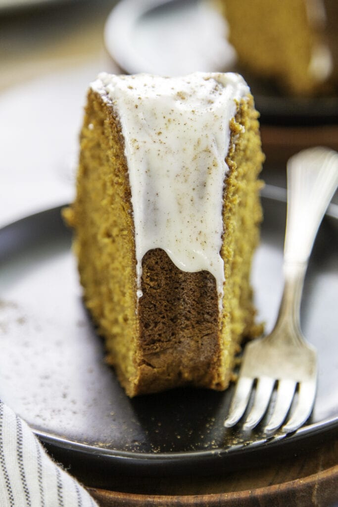 pumpkin cake slice on black plate and fork