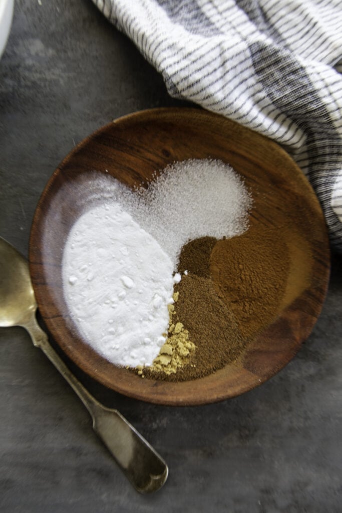 pumpkin cake seasonings on wooden plate