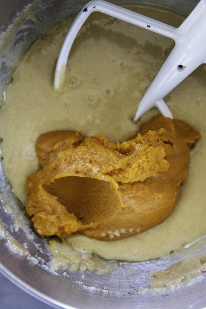 pumpkin puree in cake batter overhead shot in mixing bowl