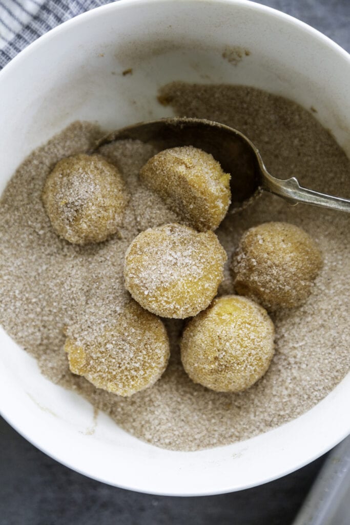 cookie dough in sugar and cinnamon
