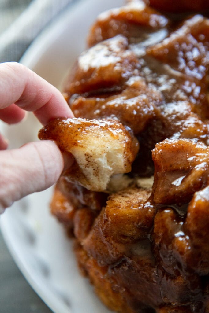 hand pulling off a piece of monkey bread