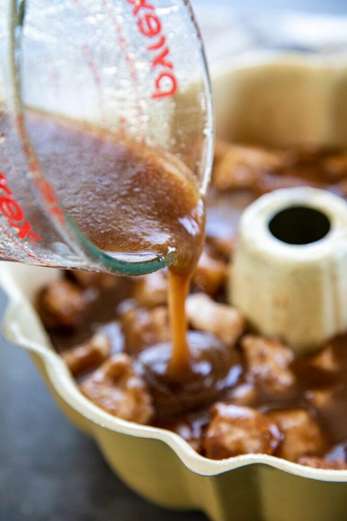 pouring caramel sauce over dough