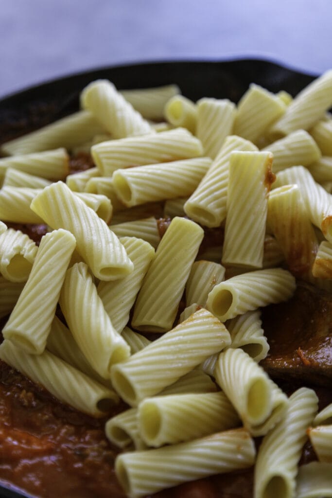 rigatoni pasta on top of sauce