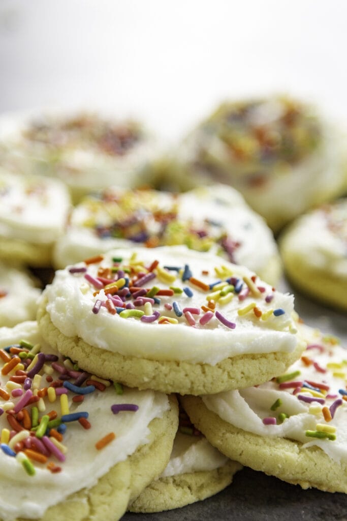 a bunch of sugar cookies frosted with sprinkles