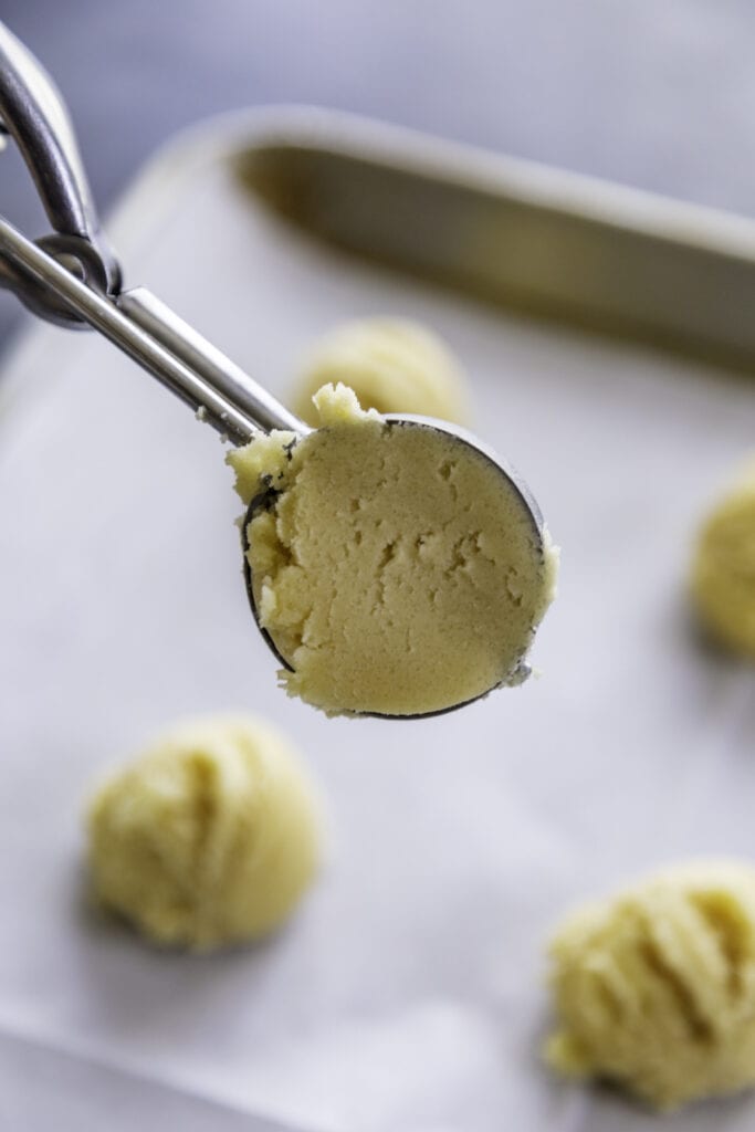 cookie scooper with cookie dough in it
