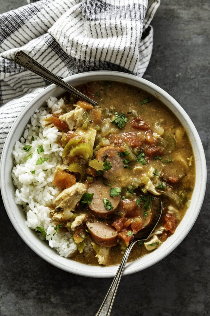 overhead shot of bowl of gumbo with two spoons