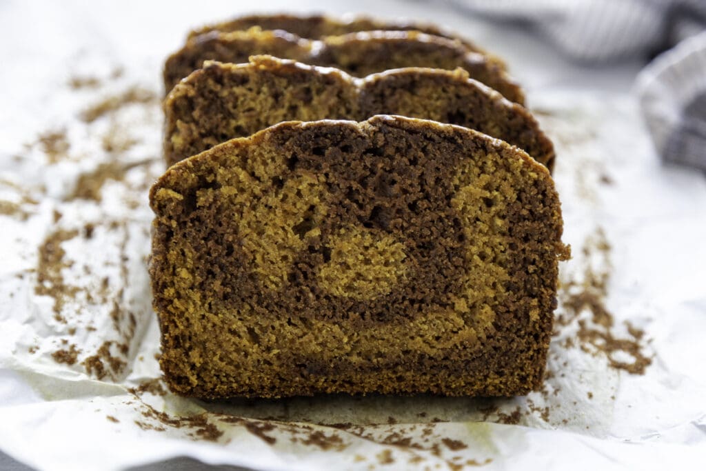 pumpkin chocolate swirl bread slice on parchment paper horizontal view on table