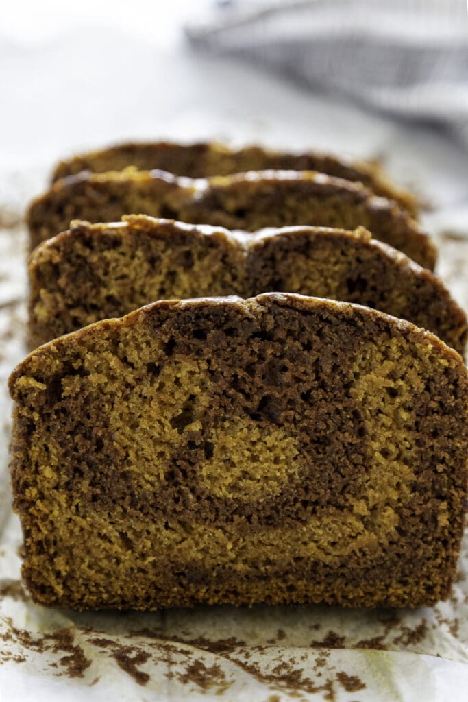 pumpkin chocolate swirl bread slice on parchment paper