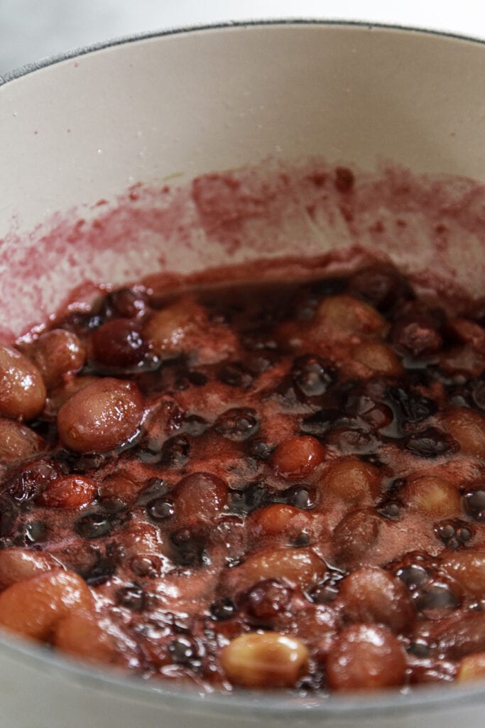 boiling pot of grapes and cranberries