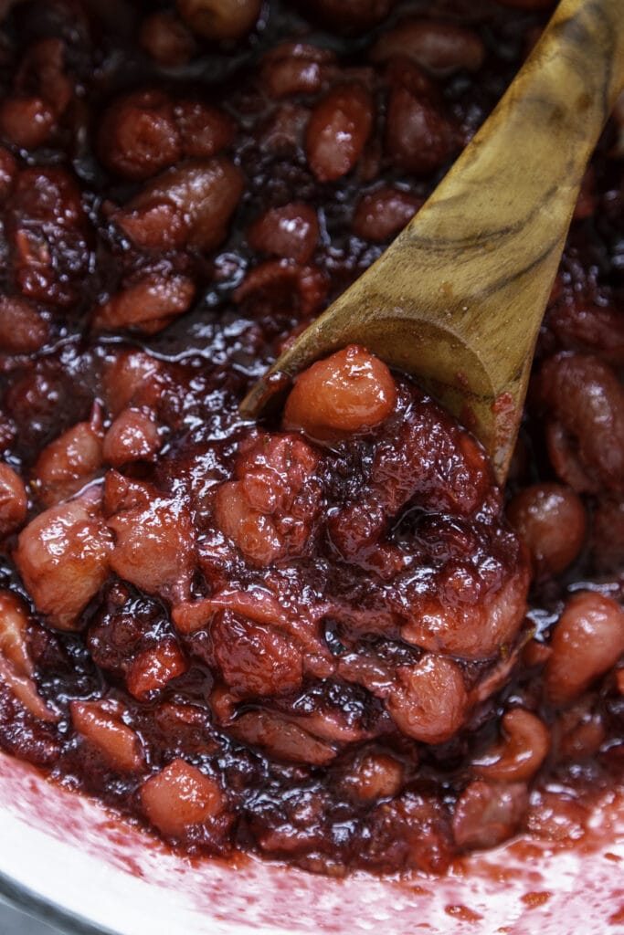 wooden spoon scooping cranberry compote