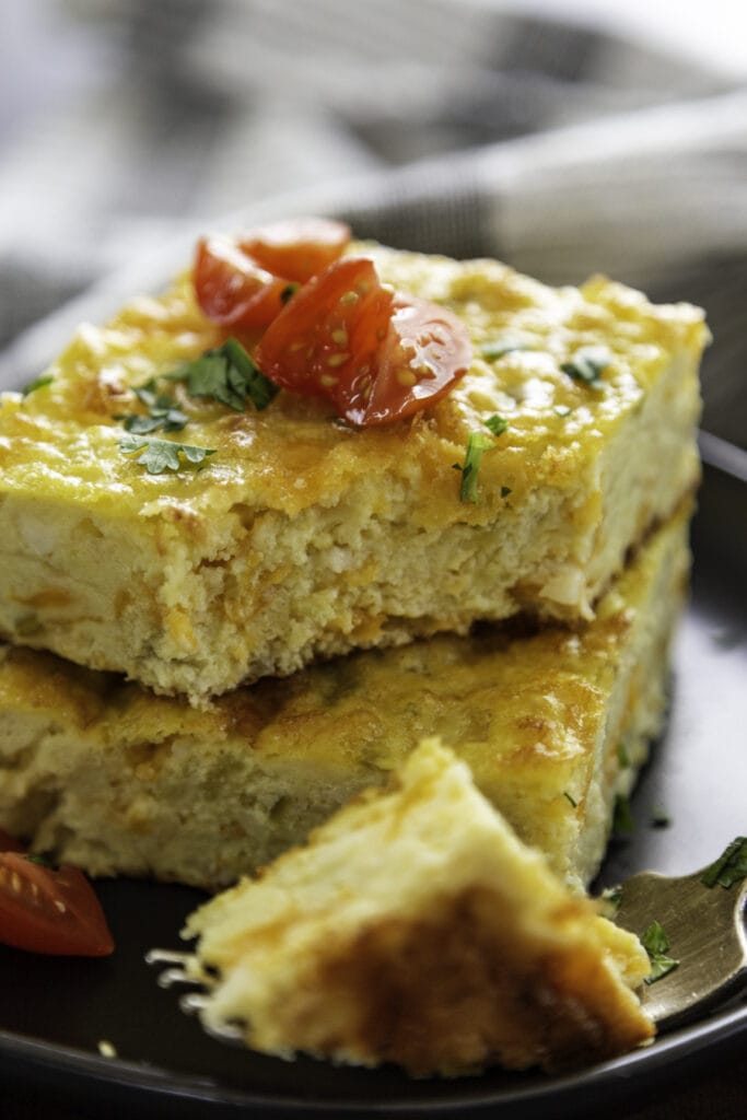 stack of slices of egg casserrole on plate with fork