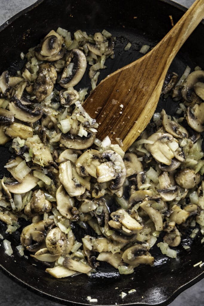 overhead shot of mushrooms and onions cooked in skillet