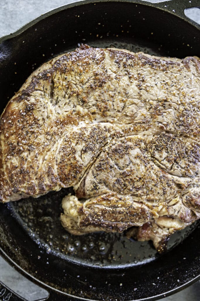 skillet with pot roast cooked