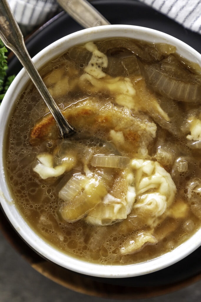 bowl with French onion soup with bread and cheese melted on top