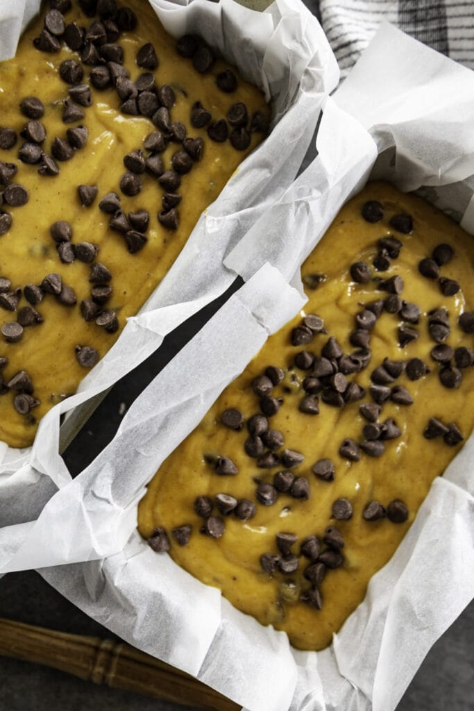 pumpkin bread batter with chocolate chips in bread loaf pans