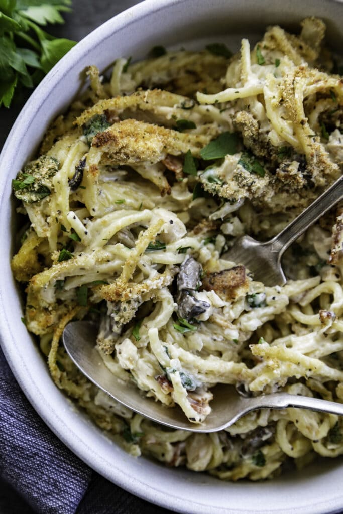 bowl of pasta with fork and spoon overhead shot