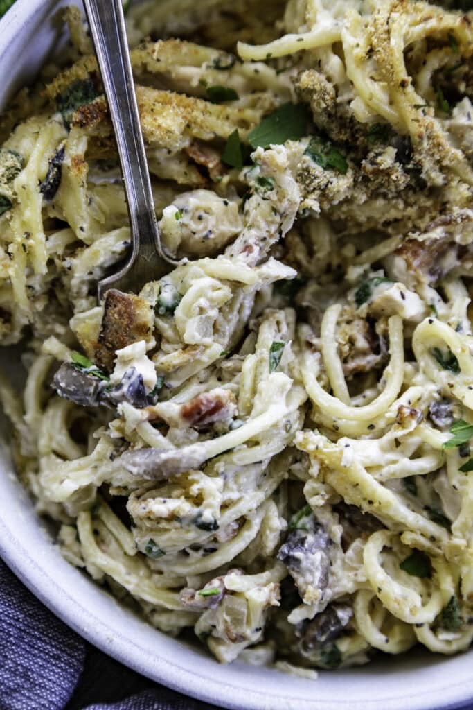 overhead shot of noodles with fork and bread crumbs