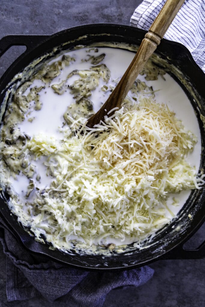 creamy pasta dish in skillet with cheese overhead shot