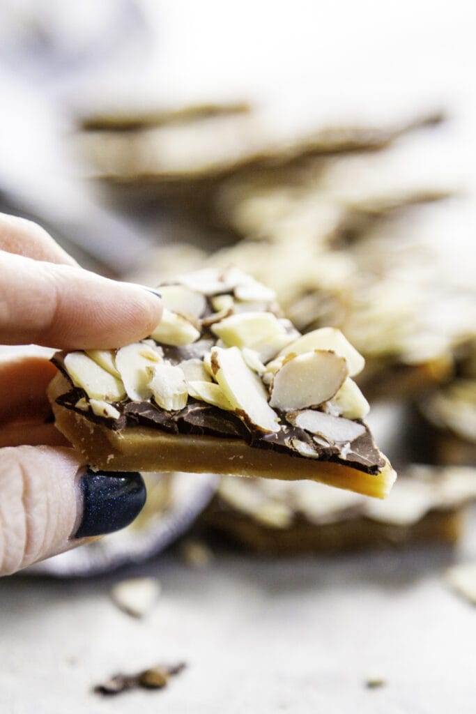 hand holding a piece of toffee