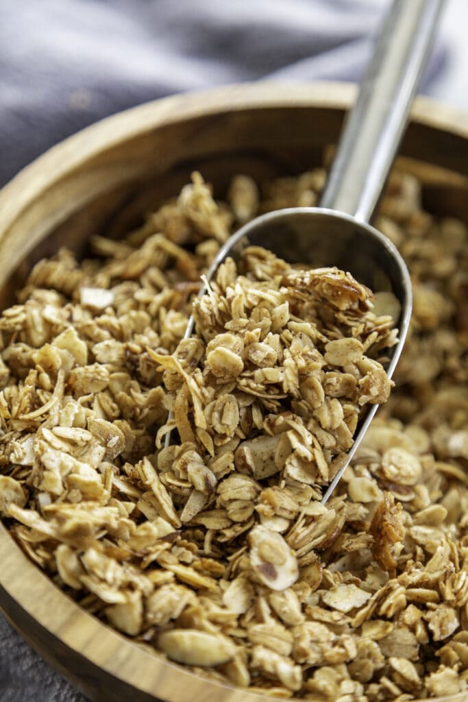 granola in wooden bowl with serving spoon