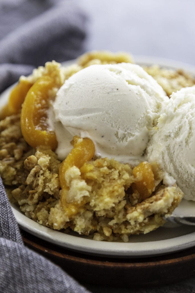 close up shot of peach dump cake on a plate