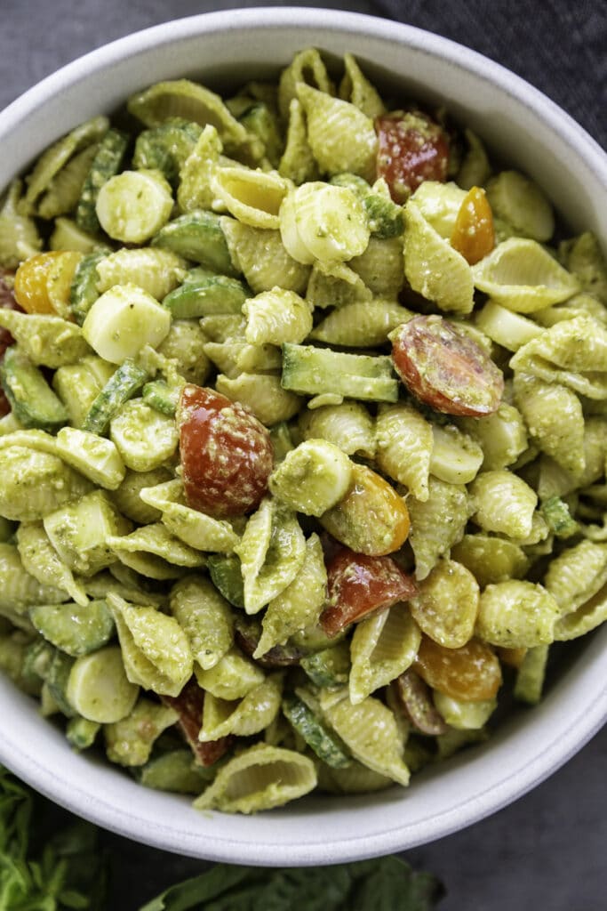 overhead shot of bowl of pesto pasta salad with vegetables