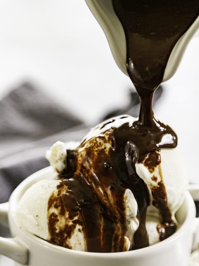 peanut butter hot fudge poured over ice cream in white bowl