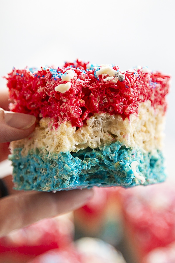 layered rice krispie treats blue, white and red with bite out of it