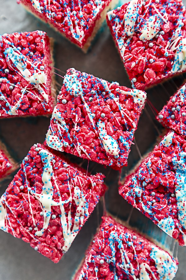 overhead shot of rice krispie treats with white chocolate drizzle and sprinkles