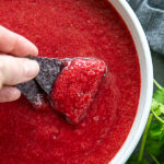 overhead shot of bowl of cherry salsa with chips