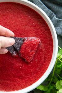 overhead shot of bowl of cherry salsa with chips