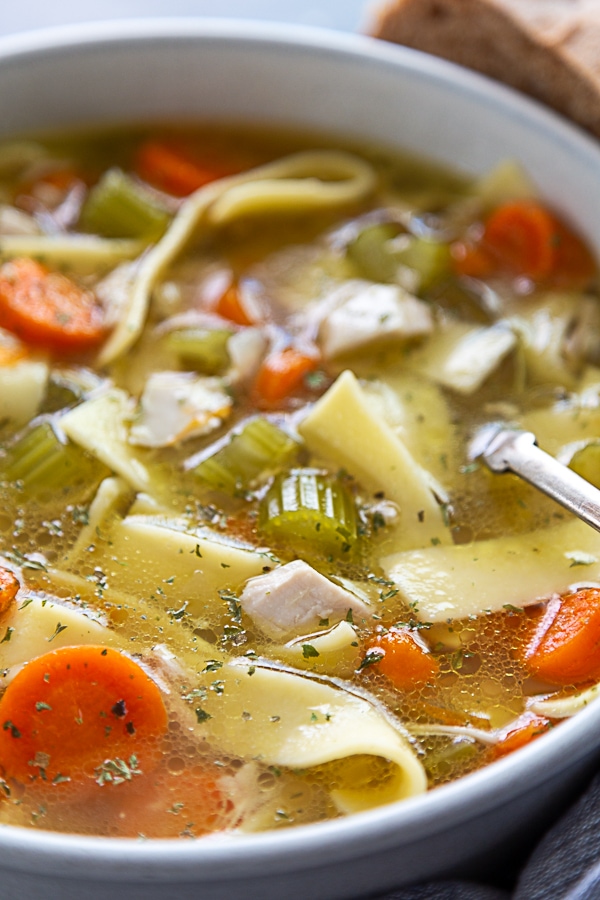 close up shot of chicken noodle soup in bowl