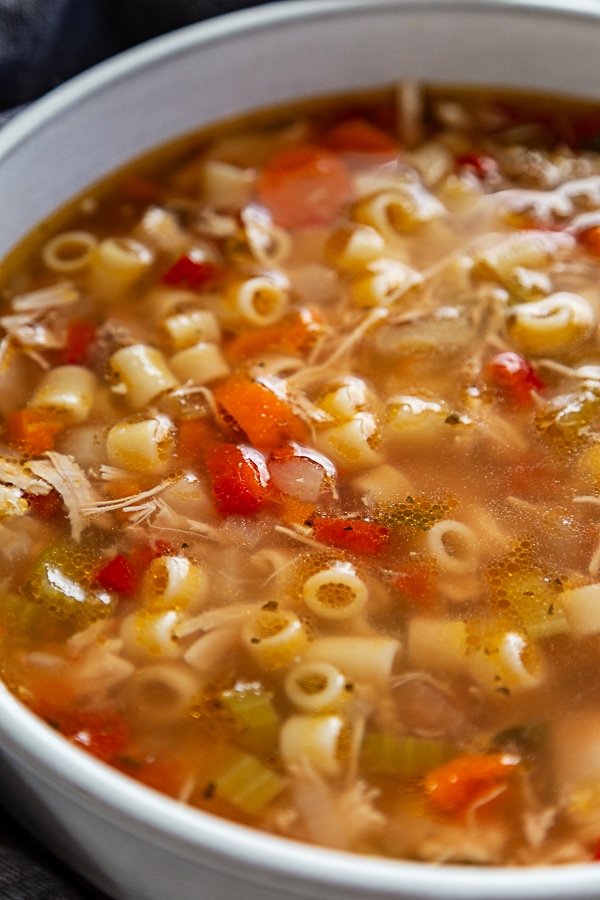 close up shot of sicilian chicken soup in white bowl