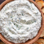 spinach artichoke dip in wood bowl with chips